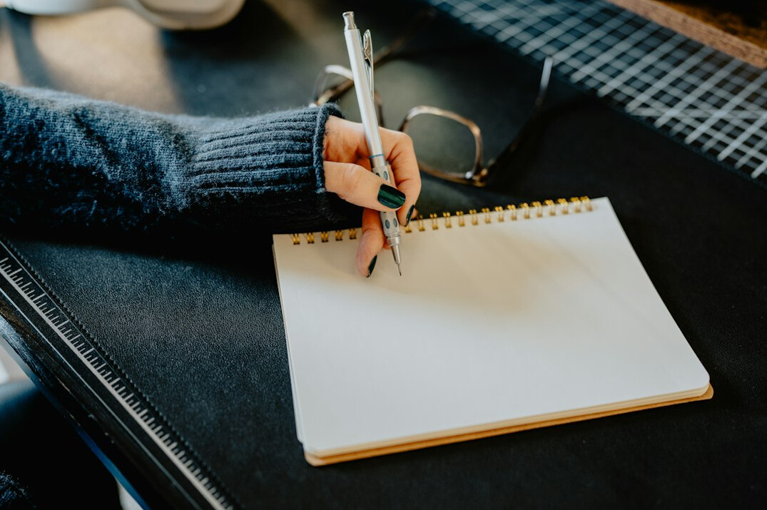 writer at desk with notebook