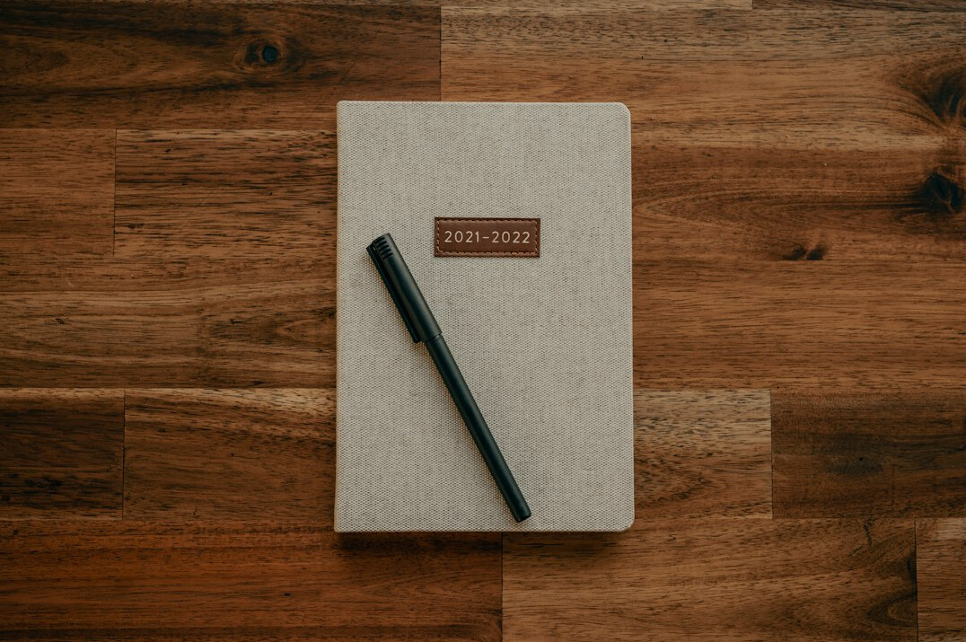 writer at desk with notebook
